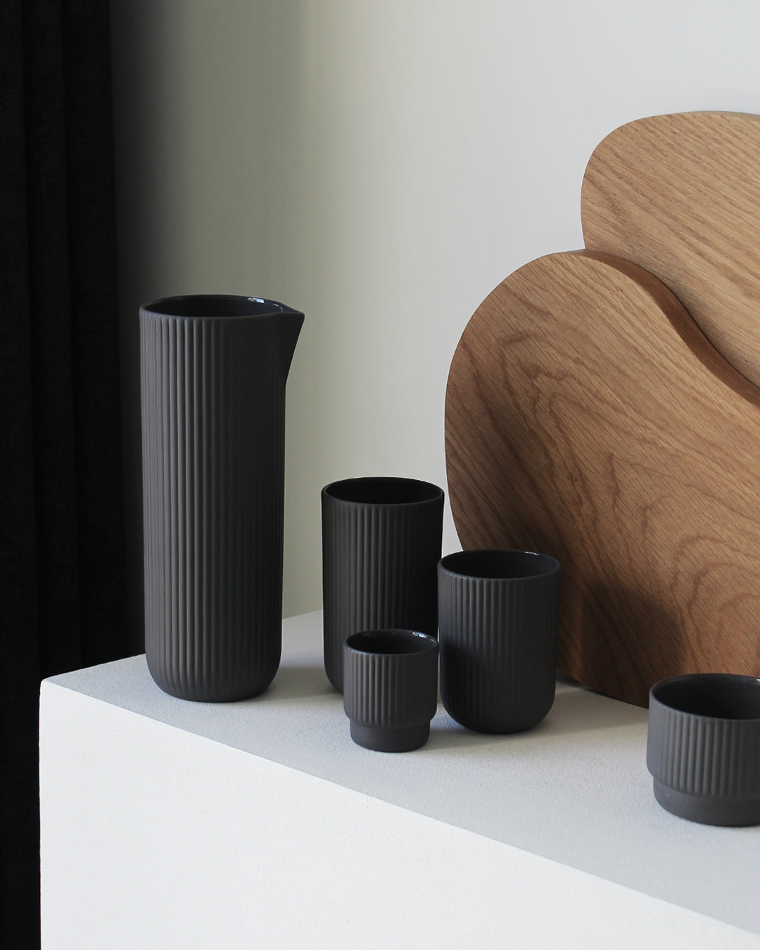 Minimalist dark grey Carafe Column by Archive Studio on table