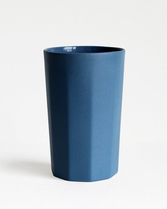 Tall stoneware mug Segmented collection in blue with textured exterior and glazed interior