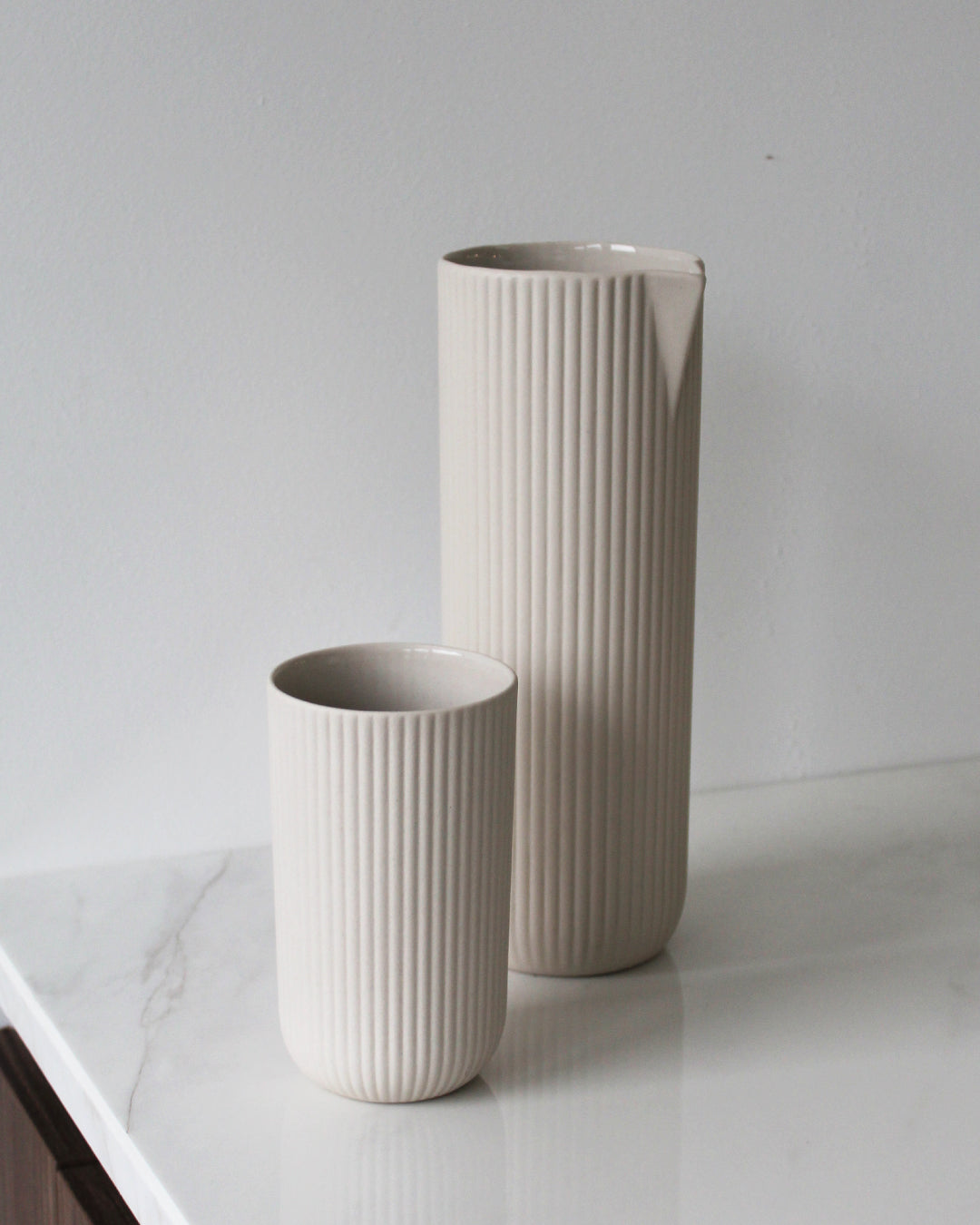 Column carafe in sand on a table setting, handmade stoneware with glazed interior and unglazed exterior, Archive Studio