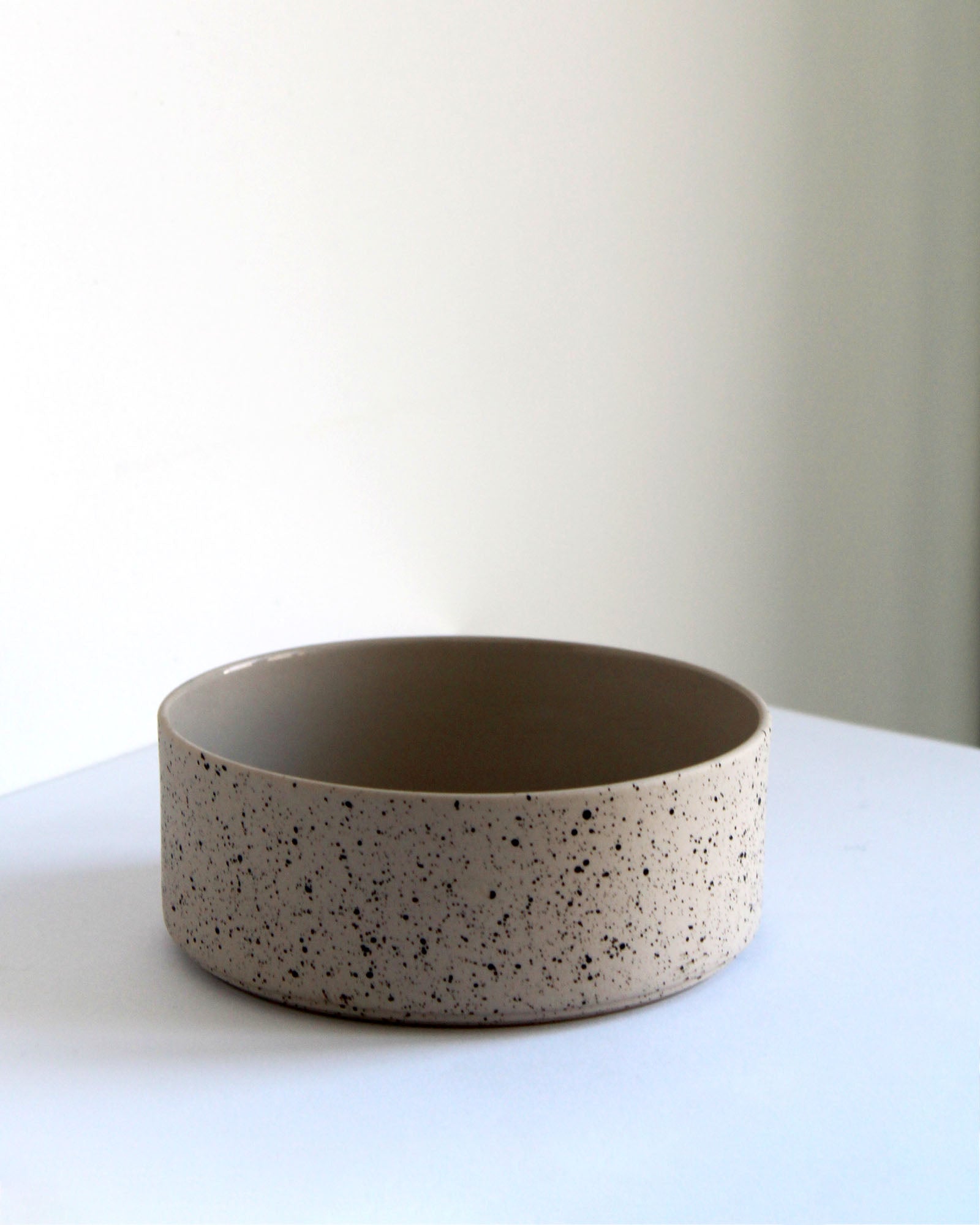 Forme Collection stoneware bowl in sand and speckled finish, glazed inside and unglazed outside, handmade, minimalist design