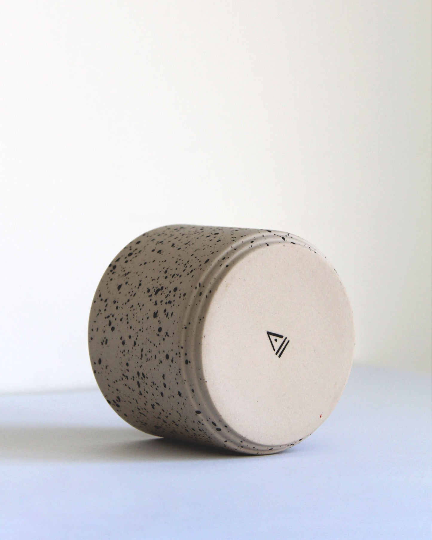 Back view of Forme Collection cappuccino mug in sand and speckled stoneware, handmade minimalist design