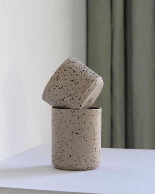 Close-up of Forme Collection coffee mug showing speckled texture and sand tone