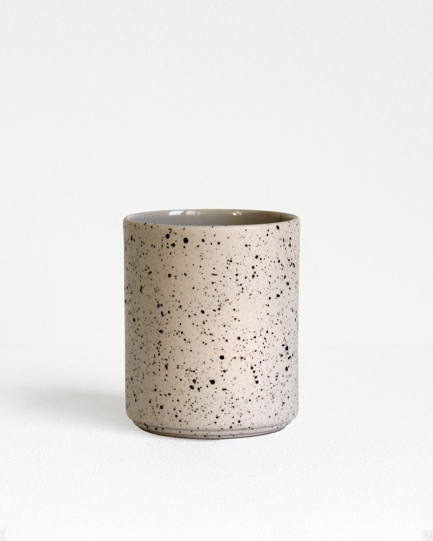 Forme Collection coffee mug in sand and speckled stoneware, glazed inside and unglazed outside, handmade, minimalist design