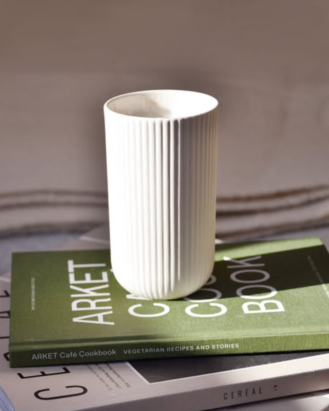 Tall Column mug in sand, handmade stoneware with glazed interior and unglazed exterior, front view, Archive Studio