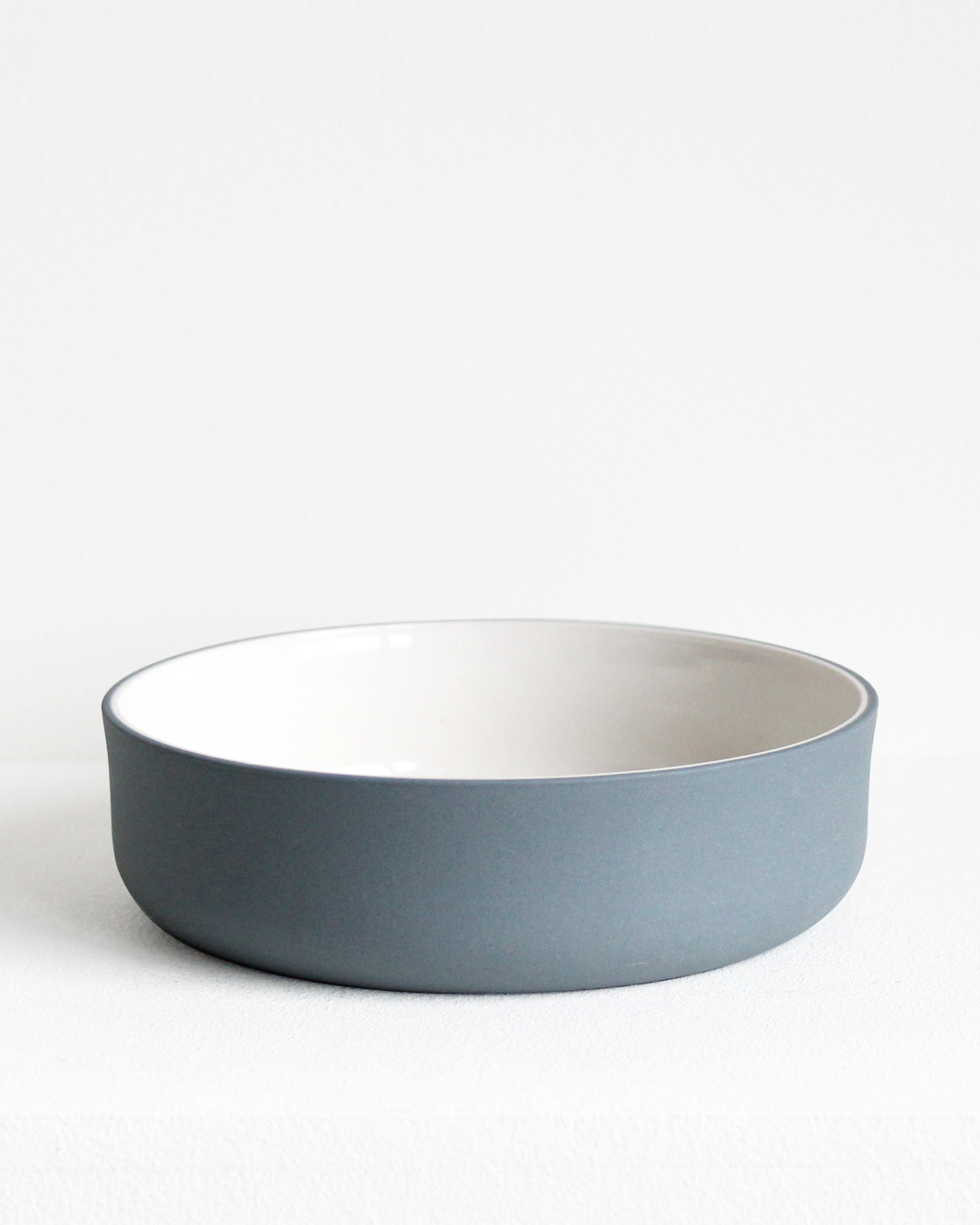 Bowl in teal and white by Archive Studio with minimalist design