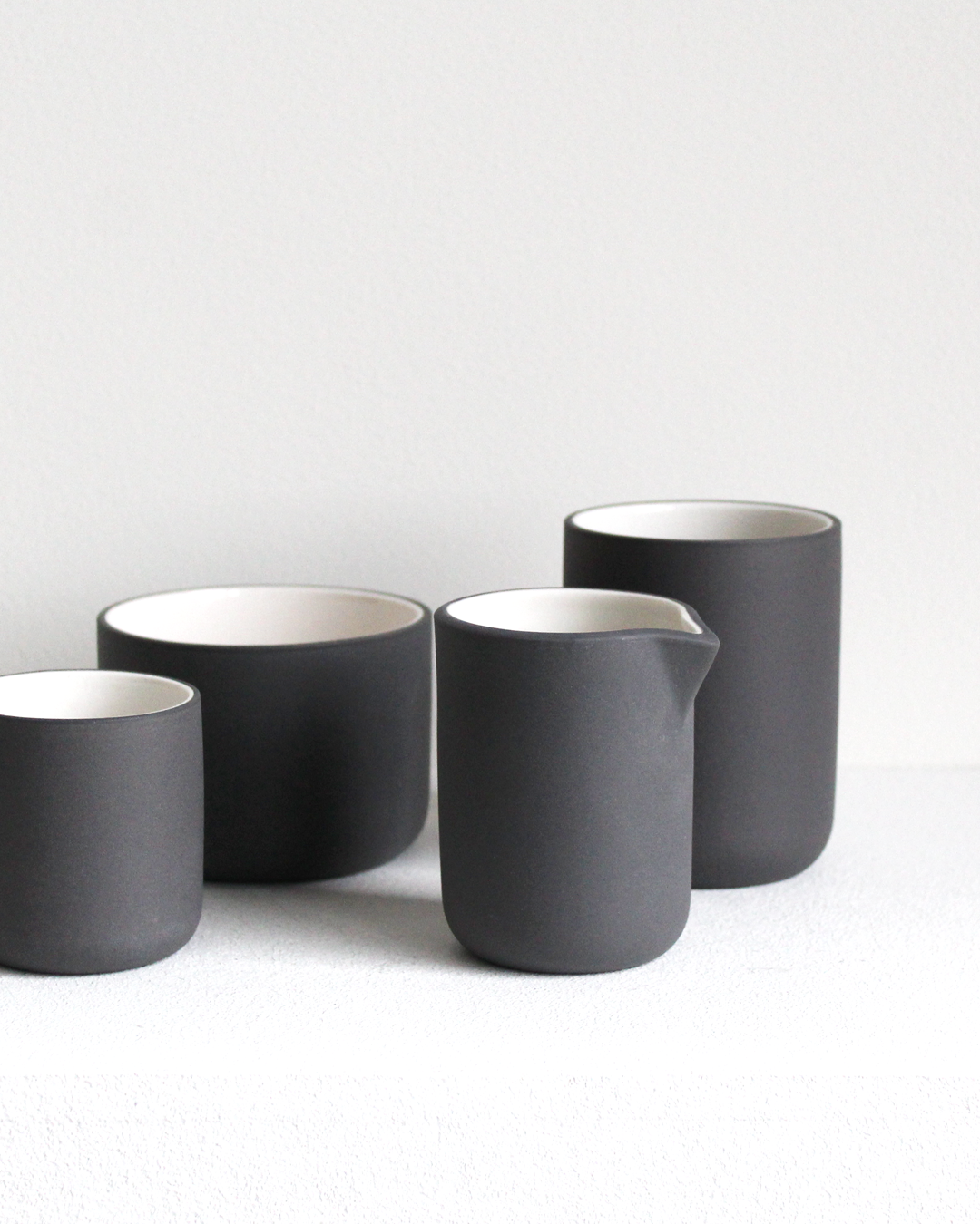 Minimalist dark grey/white Cappuccino mug Fundament by Archive Studio on table