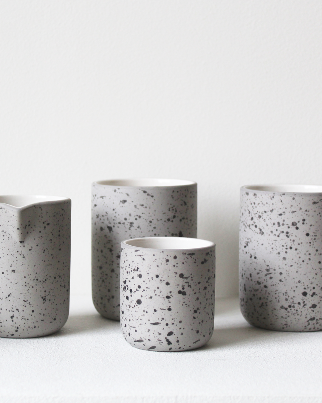 Minimalist light grey speckled/white Coffee mug Fundament by Archive Studio on table