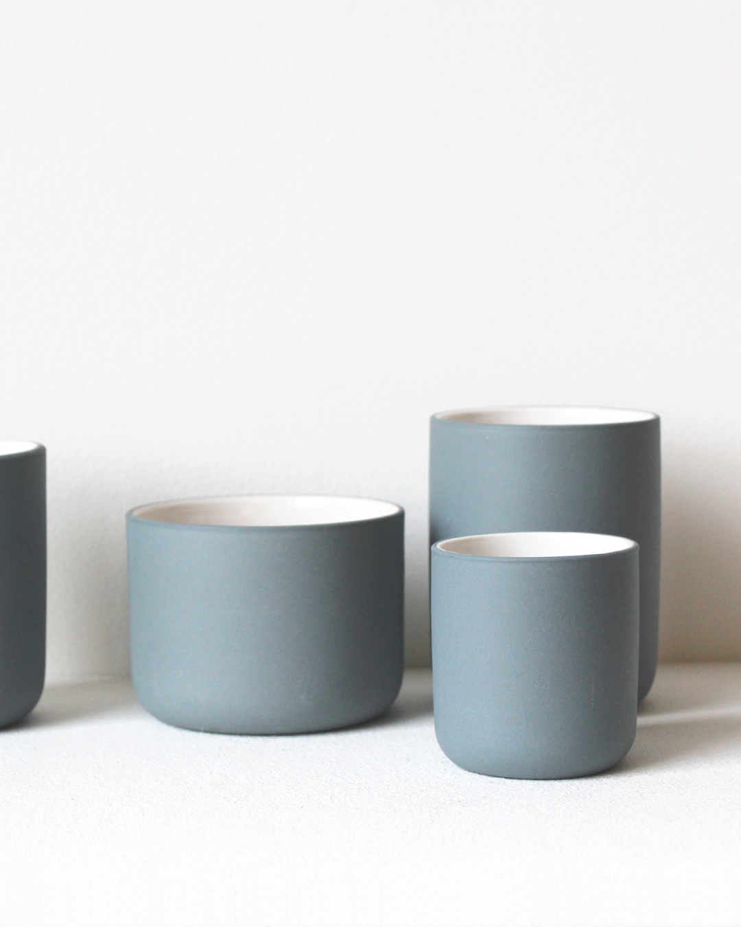 Minimalist teal/white Coffee mug Fundament by Archive Studio on table
