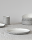 Minimalist light grey speckled/white bowl by Archive Studio on table