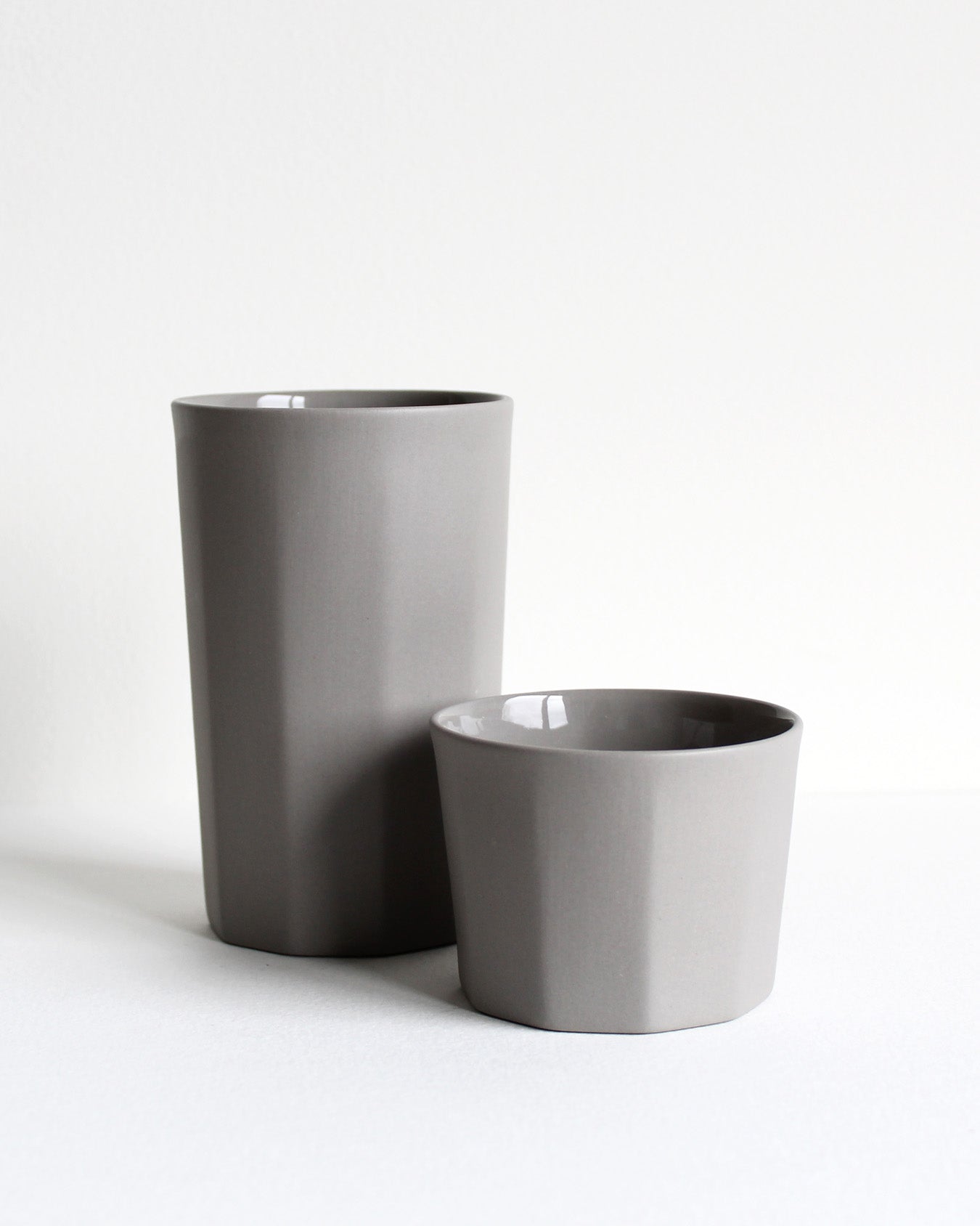 Tall ceramic mug Segmented in light grey with minimalist design and matte texture
