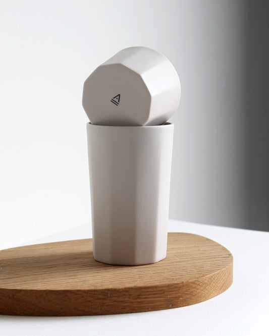 Tall Segmented stoneware mug in sand styled on a neutral table setting