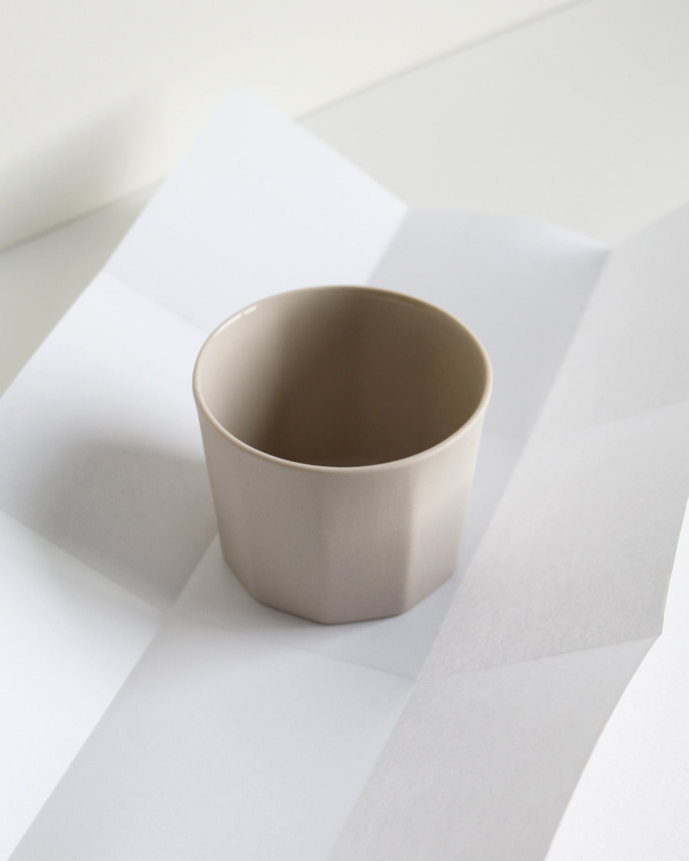 Segmented cappuccino mug in sand with tactile exterior and smooth glaze