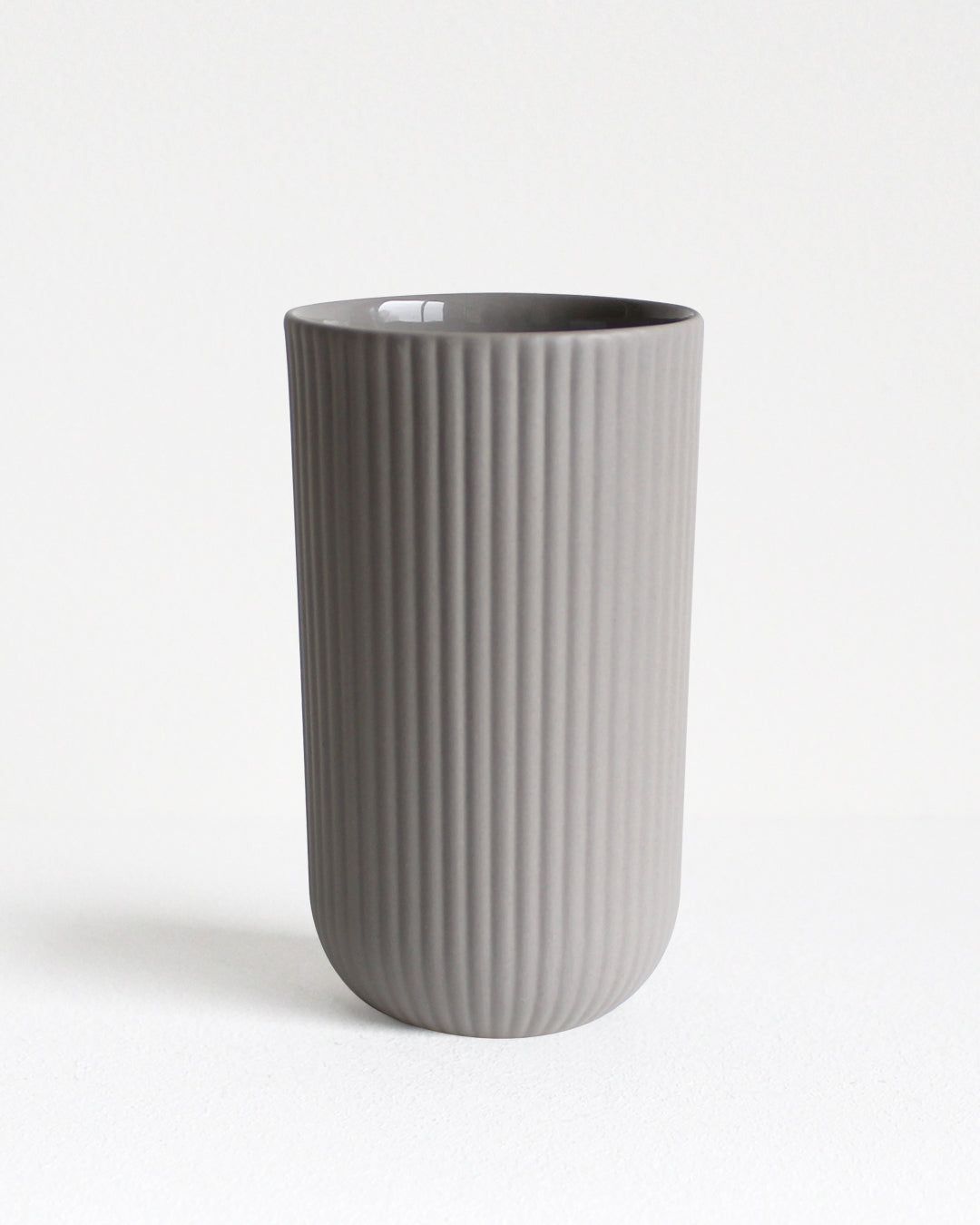 Tall Column stoneware mug in light grey with glazed interior and textured exterior