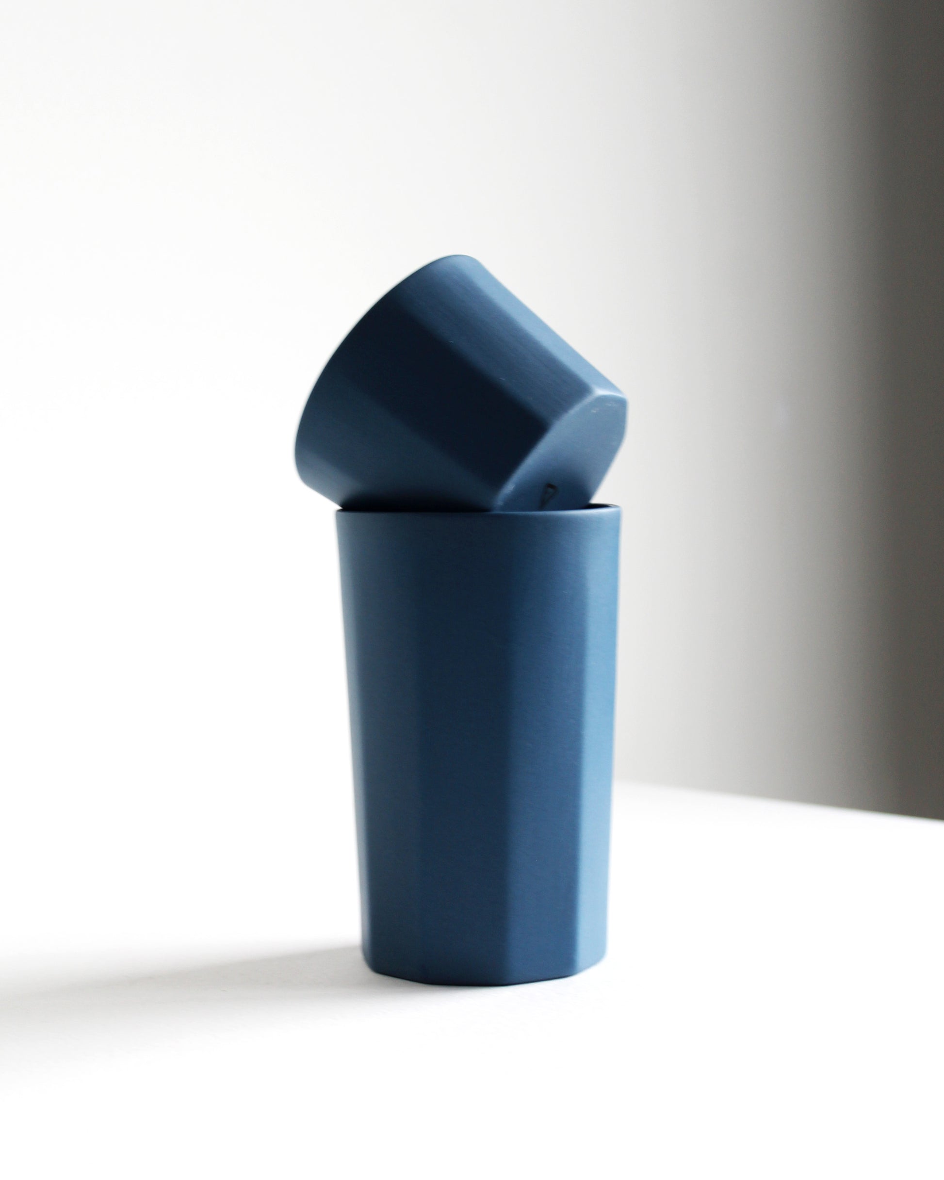 Tall Segmented stoneware mug in blue styled with a cappuccino