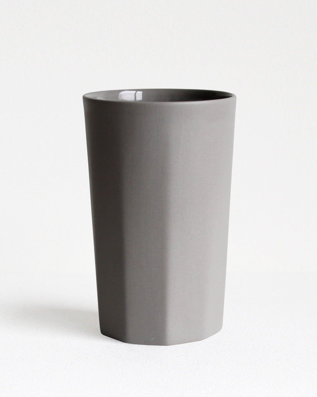 Tall stoneware mug Segmented collection in light grey with textured exterior and glazed interior