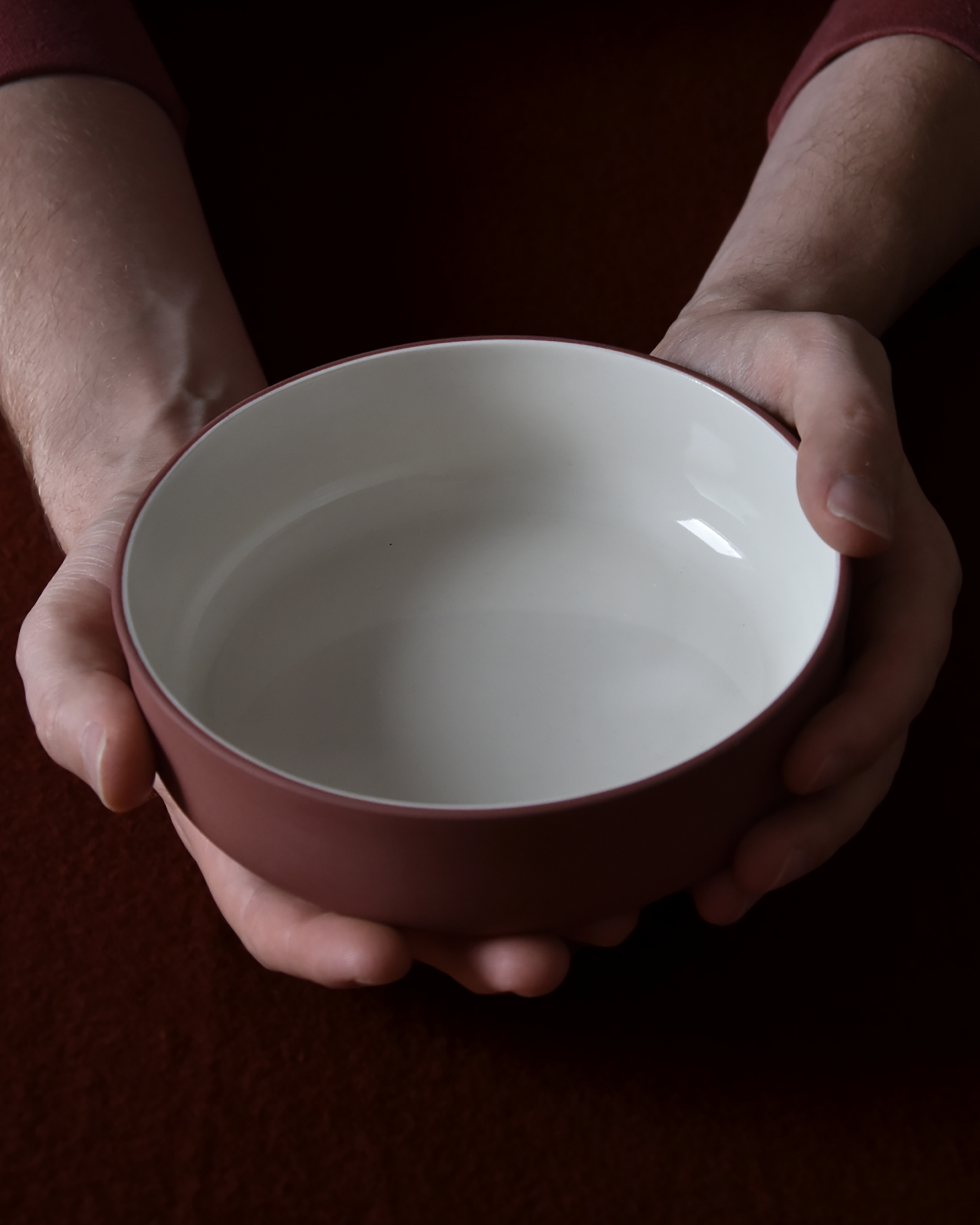Minimalist terracotta/white bowl by Archive Studio on table